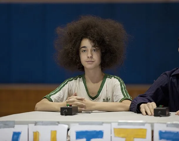 Eli Pettifog sitting in a classroom