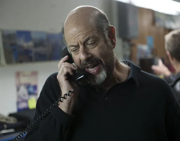 A man talking on the phone in a scene from HairBrained