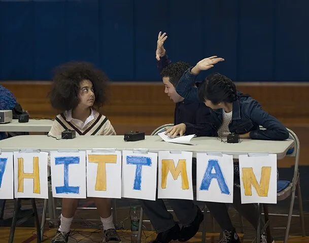 Students cheering with a Whittman banner